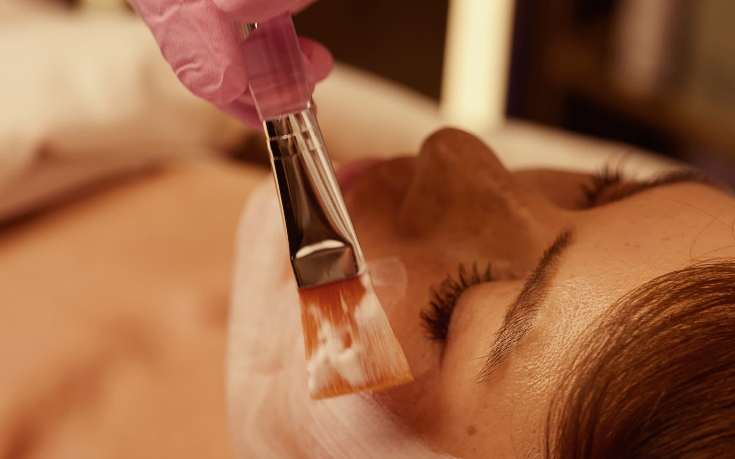 Zhanna Graeff applying a masque with a brush
