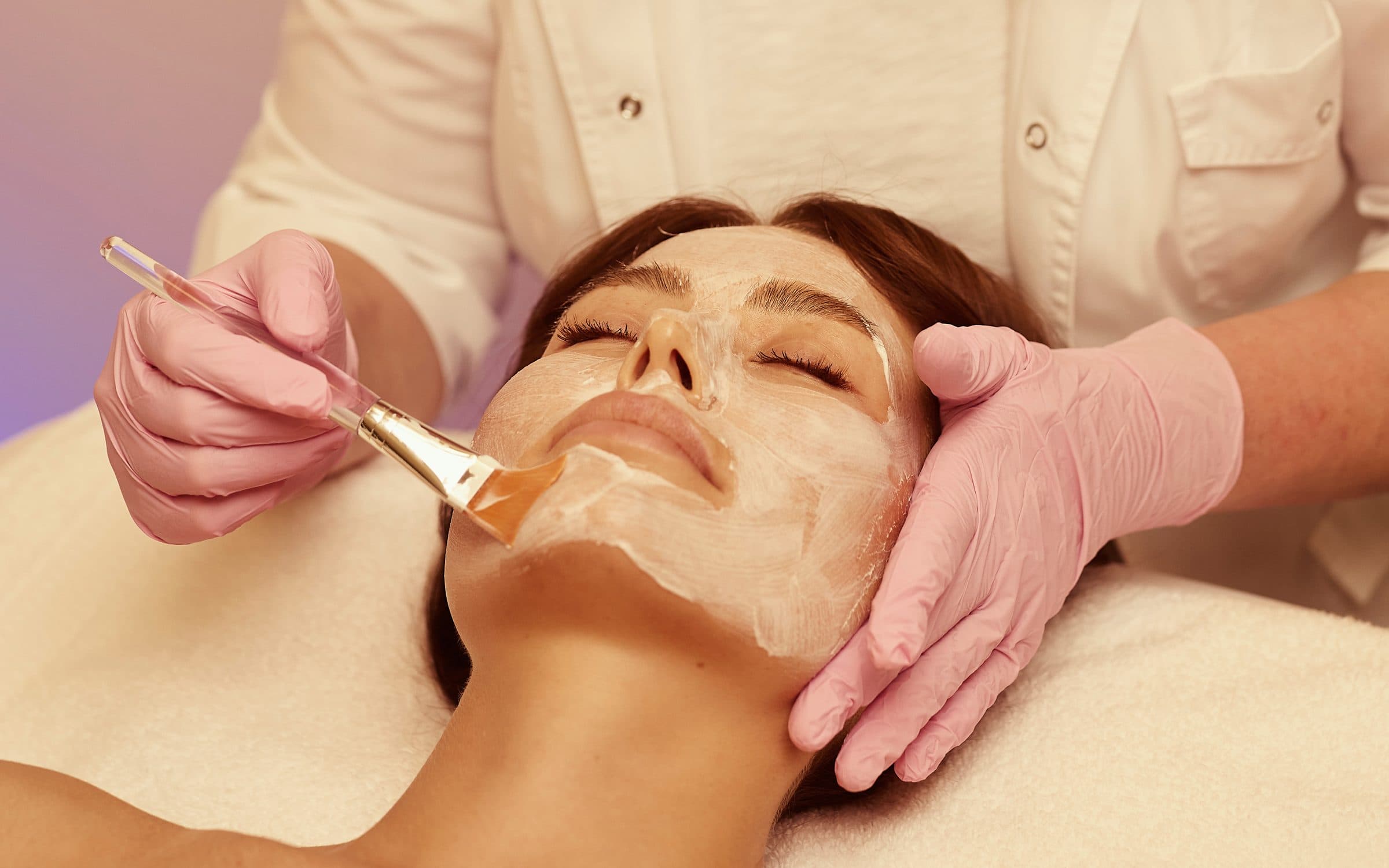 Zhanna Graeff applying a masque with a brush