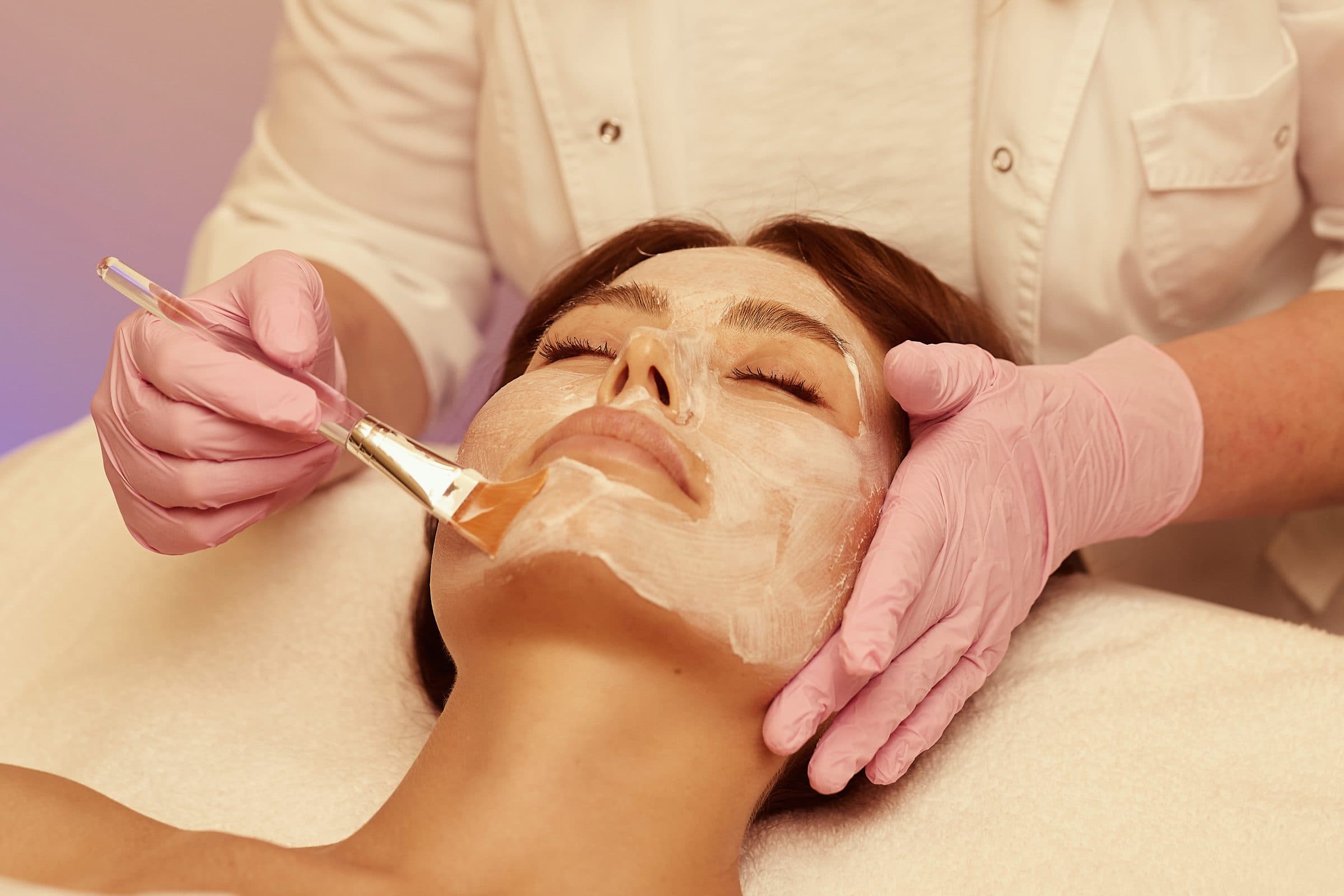 Zhanna Graeff applying a masque with a brush